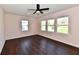 This bedroom features hardwood floors, neutral walls, a ceiling fan, and plenty of natural light from the large windows at 3015 E Sumner Ave, Indianapolis, IN 46237