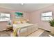 Bright bedroom featuring a wicker bed frame, pastel accents, and natural light at 3015 E Sumner Ave, Indianapolis, IN 46237