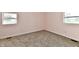 Cozy bedroom features two windows providing natural light and neutral carpeting at 3015 E Sumner Ave, Indianapolis, IN 46237