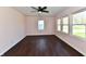 Bedroom with wood-look flooring and multiple windows for natural lighting at 3015 E Sumner Ave, Indianapolis, IN 46237