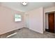 This bedroom features neutral walls, carpeted floors, a closet, and a window at 3015 E Sumner Ave, Indianapolis, IN 46237