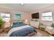 Primary bedroom featuring a TV, woven headboard, and beach-themed artwork at 3015 E Sumner Ave, Indianapolis, IN 46237