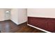 Hallway with wood-look flooring, white trim and half brick walls at 3015 E Sumner Ave, Indianapolis, IN 46237