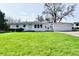 Charming single-story home with a well-manicured lawn and an attached two car garage at 3015 E Sumner Ave, Indianapolis, IN 46237