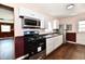 This kitchen features modern appliances, white cabinets, and a brick accent wall at 3015 E Sumner Ave, Indianapolis, IN 46237