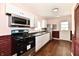 Well-lit kitchen with white cabinetry, modern appliances, and wood-look flooring at 3015 E Sumner Ave, Indianapolis, IN 46237