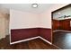 This living room features wood floors, a brick accent wall, and neutral walls at 3015 E Sumner Ave, Indianapolis, IN 46237