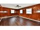 Spacious living room featuring dark wood paneling and wood-look flooring, creating a cozy atmosphere at 3015 E Sumner Ave, Indianapolis, IN 46237