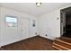 Bright mudroom featuring wood paneling, dark wood floors, and ample natural light from two windows at 3015 E Sumner Ave, Indianapolis, IN 46237