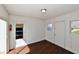 This sun room features wood floors, white wood paneled walls, and natural light at 3015 E Sumner Ave, Indianapolis, IN 46237