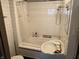 Bathroom with white tile, shower-tub combo and unique sink at 3070 N Layman Ave, Indianapolis, IN 46218