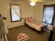 Cozy bedroom featuring natural light from the window and carpeted floors at 3070 N Layman Ave, Indianapolis, IN 46218