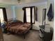 Bedroom with a bed, desk and chair and natural light from the window at 3070 N Layman Ave, Indianapolis, IN 46218
