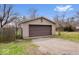 Spacious two-car detached garage with a gravel driveway and a gated entry at 3070 N Layman Ave, Indianapolis, IN 46218