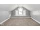 Finished attic space featuring carpeted floors, neutral paint, a window seat and arch window at 317 E 37Th St, Indianapolis, IN 46205