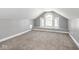 Finished attic space featuring carpeted floors, neutral paint, a window seat and arch window at 317 E 37Th St, Indianapolis, IN 46205