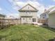 Back yard with green grass, patio, and fencing between neighbors for privacy at 317 E 37Th St, Indianapolis, IN 46205
