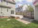 A backyard patio with steps leads to the lawn, a wooden fence separates the houses at 317 E 37Th St, Indianapolis, IN 46205