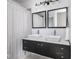 Modern bathroom boasts double sink vanity with sleek fixtures and large framed mirrors at 317 E 37Th St, Indianapolis, IN 46205