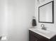 Bathroom featuring a modern sink with a dark wood vanity and a large mirror at 317 E 37Th St, Indianapolis, IN 46205