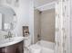 Bathroom featuring modern fixtures, a vanity, toilet, tub and shower with floral shower curtain at 317 E 37Th St, Indianapolis, IN 46205