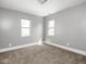 Bedroom featuring carpeted floors and two bright, sunlit windows at 317 E 37Th St, Indianapolis, IN 46205