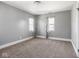 Bedroom with carpeted floors, two windows, and grey walls at 317 E 37Th St, Indianapolis, IN 46205