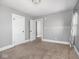 Bedroom with neutral carpet, grey walls, white trim and paneled doors at 317 E 37Th St, Indianapolis, IN 46205