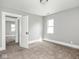 Neutral bedroom with carpeted floors, white trim, and ample natural light from a window at 317 E 37Th St, Indianapolis, IN 46205