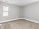 Bright bedroom featuring neutral walls, carpeted floors, and a double hung window at 317 E 37Th St, Indianapolis, IN 46205