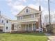 Charming two-story home with a covered front porch and a well-manicured lawn at 317 E 37Th St, Indianapolis, IN 46205
