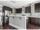 Kitchen with stainless steel refrigerator, dark cabinets and quartz countertop at 317 E 37Th St, Indianapolis, IN 46205