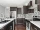 Kitchen featuring stainless steel appliances, dark cabinets, and mosaic backsplash at 317 E 37Th St, Indianapolis, IN 46205