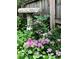 Beautiful backyard landscaping with a stone bird bath surrounded by pink yarrow at 317 E 37Th St, Indianapolis, IN 46205