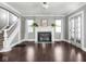 Inviting living room featuring hardwood floors, fireplace, and staircase access at 317 E 37Th St, Indianapolis, IN 46205