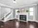 Bright living room with hardwood floors, fireplace, and staircase at 317 E 37Th St, Indianapolis, IN 46205