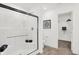 Modern bathroom featuring a tiled shower with glass doors, a toilet, and a doorway to a walk-in closet at 3326 Wetherby Pl, Danville, IN 46122