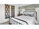 Charming bedroom with stylish mirrors, black metal bed frame, and neutral accents at 3326 Wetherby Pl, Danville, IN 46122