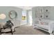 Adorable Bedroom with crib, rocker, dresser, natural light, and whimsical decor for a cozy atmosphere at 3326 Wetherby Pl, Danville, IN 46122