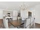 Dining area features a modern chandelier, dining table, and access to the kitchen at 3326 Wetherby Pl, Danville, IN 46122