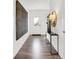 Bright foyer with wood-look floors, stylish console table, mirror and eye-catching wall art at 3326 Wetherby Pl, Danville, IN 46122