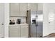 Kitchenette includes stainless steel refrigerator, gray cabinets, and a granite countertop at 3326 Wetherby Pl, Danville, IN 46122