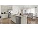 Modern kitchen features an island with a sink and stainless steel appliances and a view of dining room at 3326 Wetherby Pl, Danville, IN 46122
