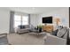 Bright and airy living room with a large TV and lots of natural light at 3326 Wetherby Pl, Danville, IN 46122