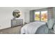 Bright main bedroom boasts a calming color palette, large windows, dresser, and plush bedding at 3326 Wetherby Pl, Danville, IN 46122