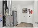 Utility Room featuring a water heater, furnace, and modern flooring at 3326 Wetherby Pl, Danville, IN 46122