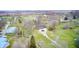 A birds eye view showing the brick ranch home with long driveway, creek and adjacent farm at 345 E Main St, Jamestown, IN 46147