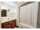 Bathroom featuring a shower/tub combo and a vanity with wood cabinets and white countertop at 345 E Main St, Jamestown, IN 46147