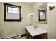 Bathroom with wood-framed window and shutters; vanity and sink with white countertop at 345 E Main St, Jamestown, IN 46147