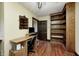 Cozy bedroom with hardwood floors, built-in shelves, a computer desk, and natural lighting at 345 E Main St, Jamestown, IN 46147